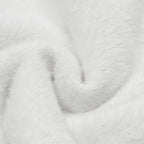 Close-up of soft white fabric texture for the Sweet Bear Knit Sweater, showcasing its cozy material