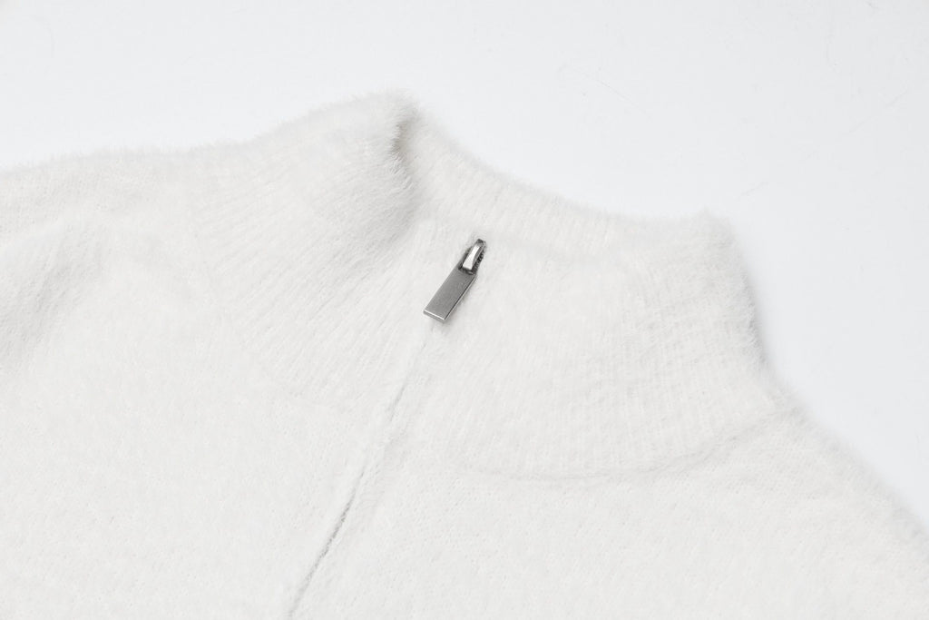 Close-up of a cozy white Sweet Bear Knit Sweater with a zip collar detail