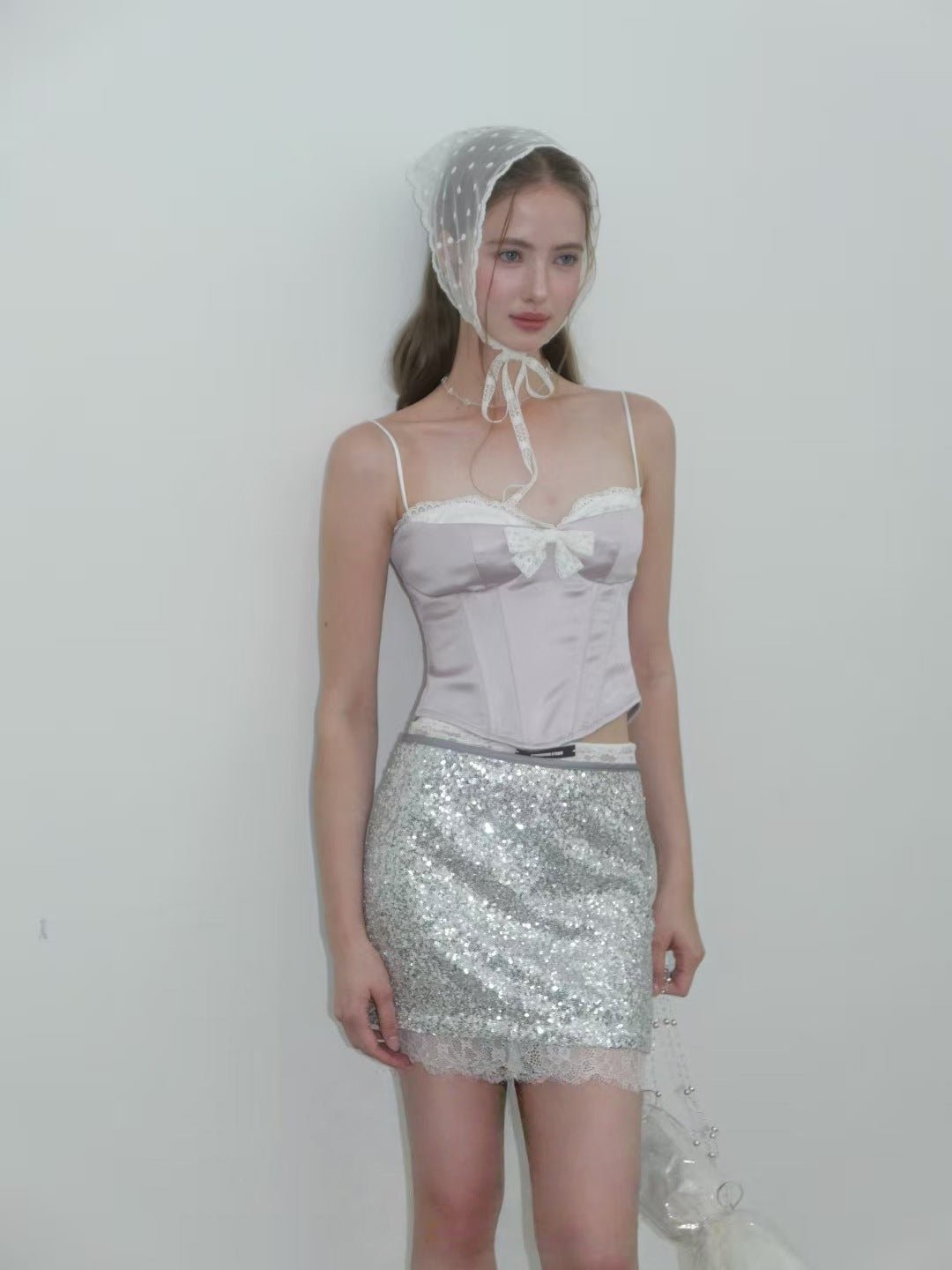Sweet Desire Pink Bow Camisole with delicate lace details styled with a sparkly silver skirt