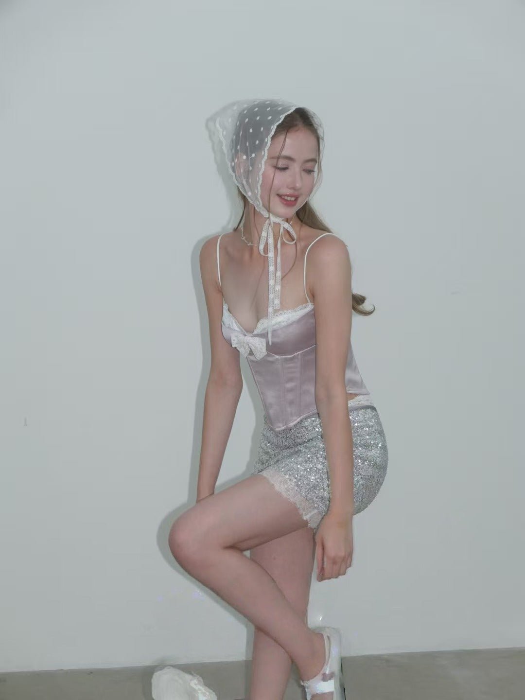 Sweet Desire Pink Bow Camisole styled with shimmering sequined shorts and a white bonnet