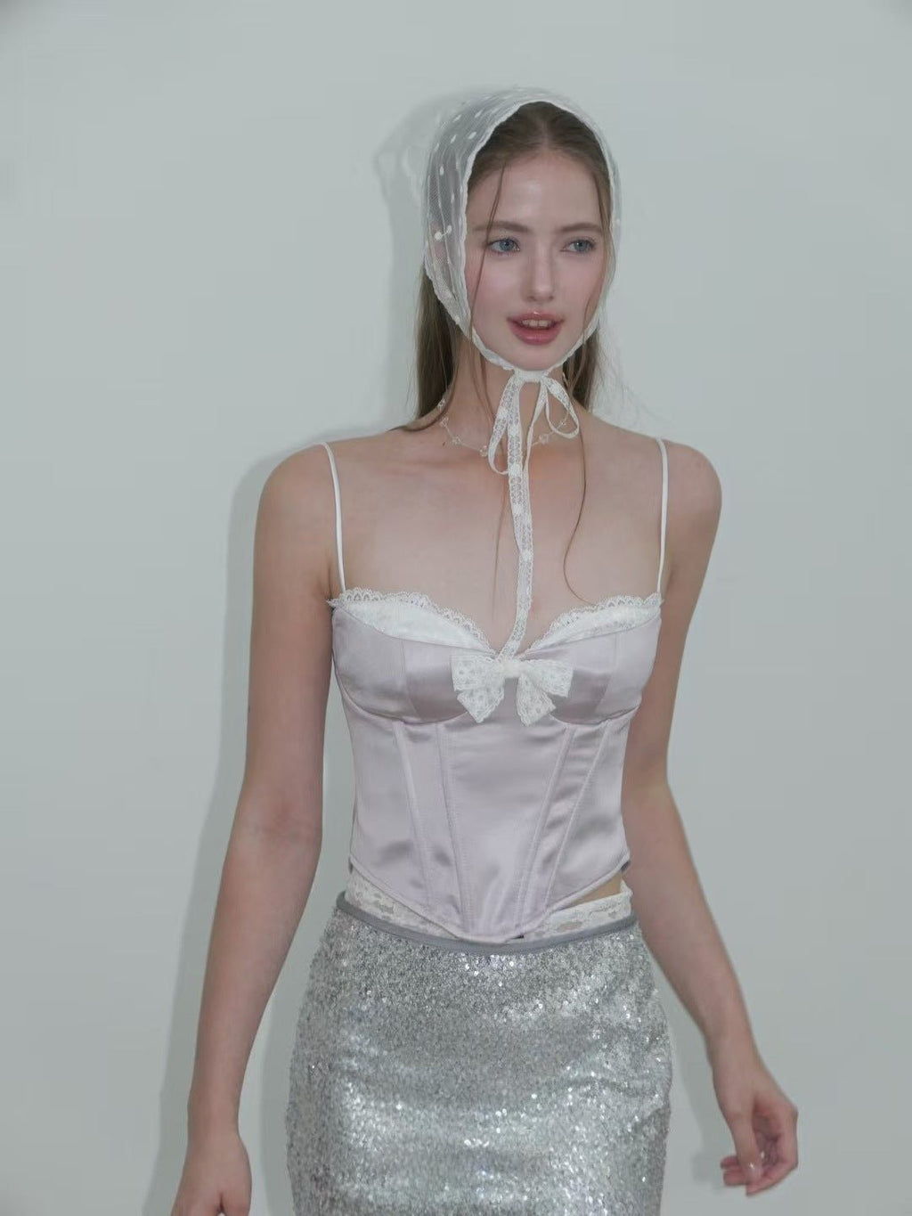 Model wearing the Sweet Desire Pink Bow Camisole with lace trim and stylish headscarf