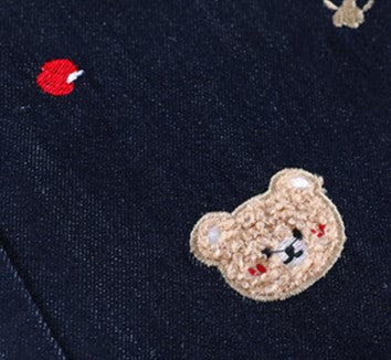 Close-up of Teddy Stitch Wide Leg Jeans featuring playful bear embroidery and colorful details