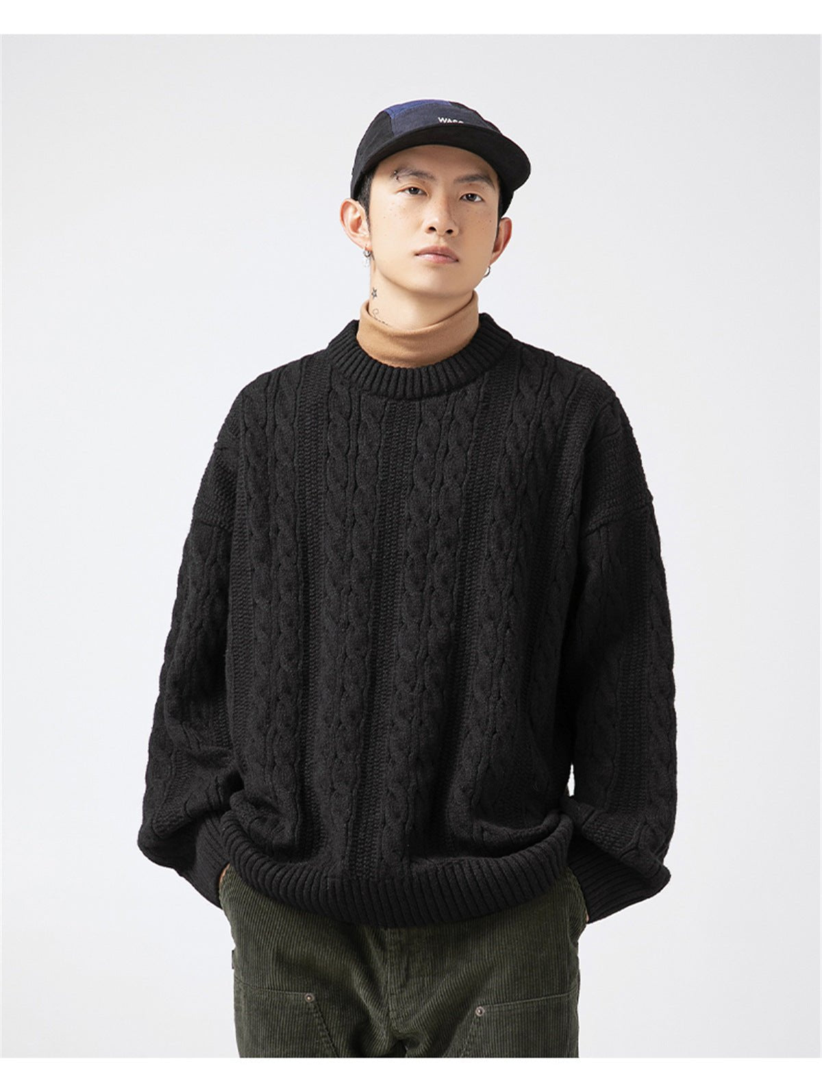 Casual model wearing a black Textured Cable Knit Sweater with loose fit and ribbed details