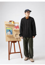 Casual model wearing a black Textured Cable Knit Sweater with stylish green pants and accessories