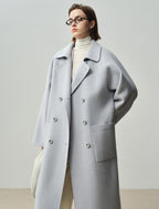 The Amaya Pastel Coat in light gray featuring a relaxed fit and large front pockets