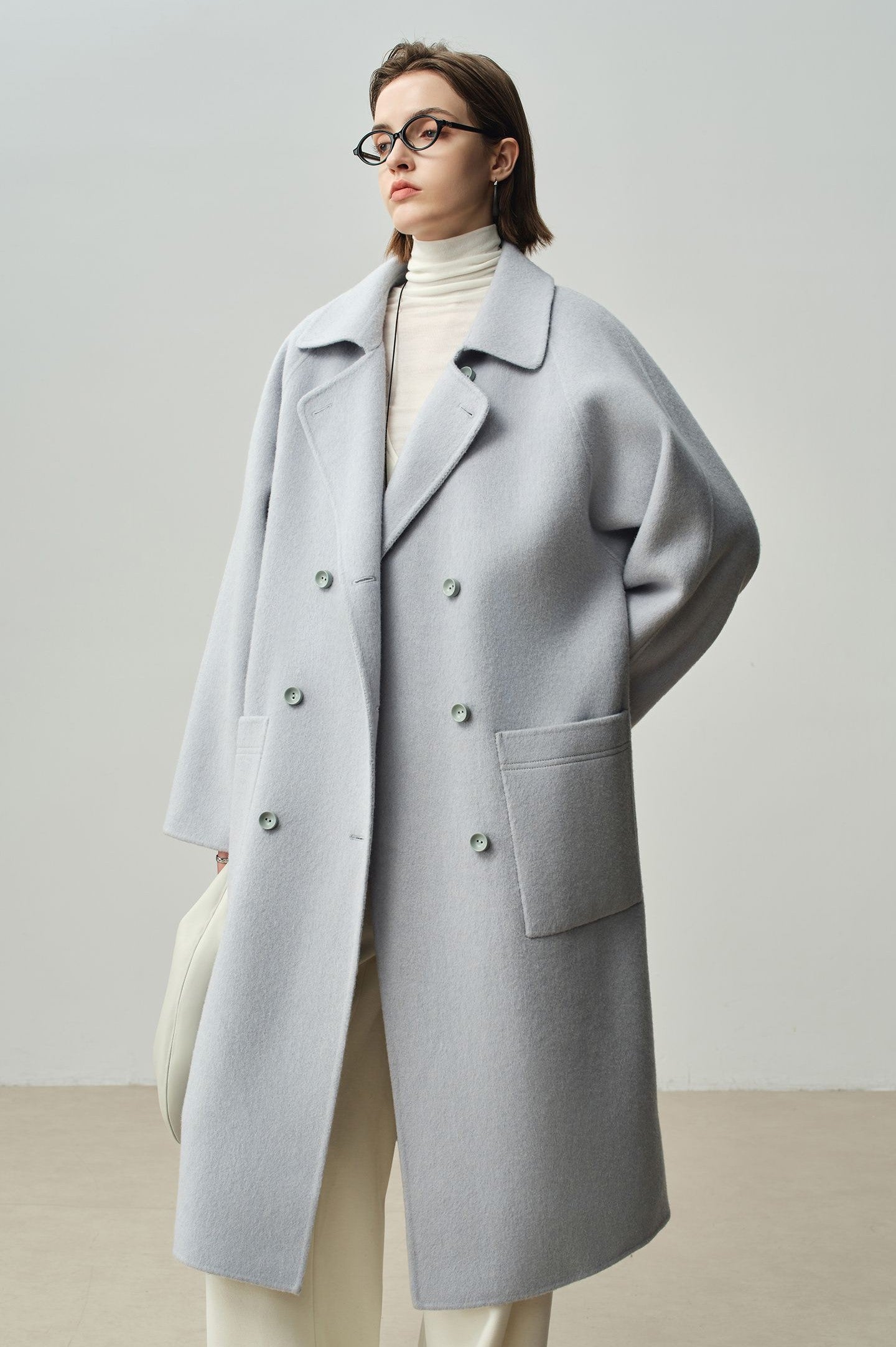 The Amaya Pastel Coat in soft gray with a relaxed fit and large buttons, perfect for stylish layering