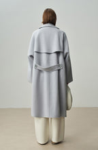 The Amaya Pastel Coat in light grey with a unique back design and stylish oversized fit