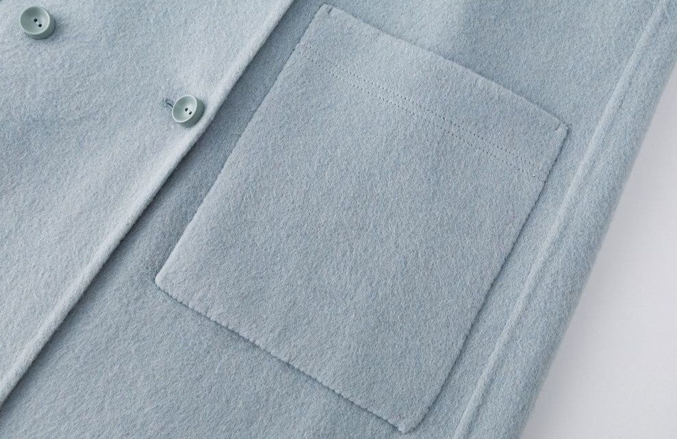 Close-up of The Amaya Pastel Coat featuring a soft fabric and a front pocket detail