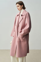 The Amaya Pastel Coat in soft pink with a relaxed fit and oversized pockets for a stylish look