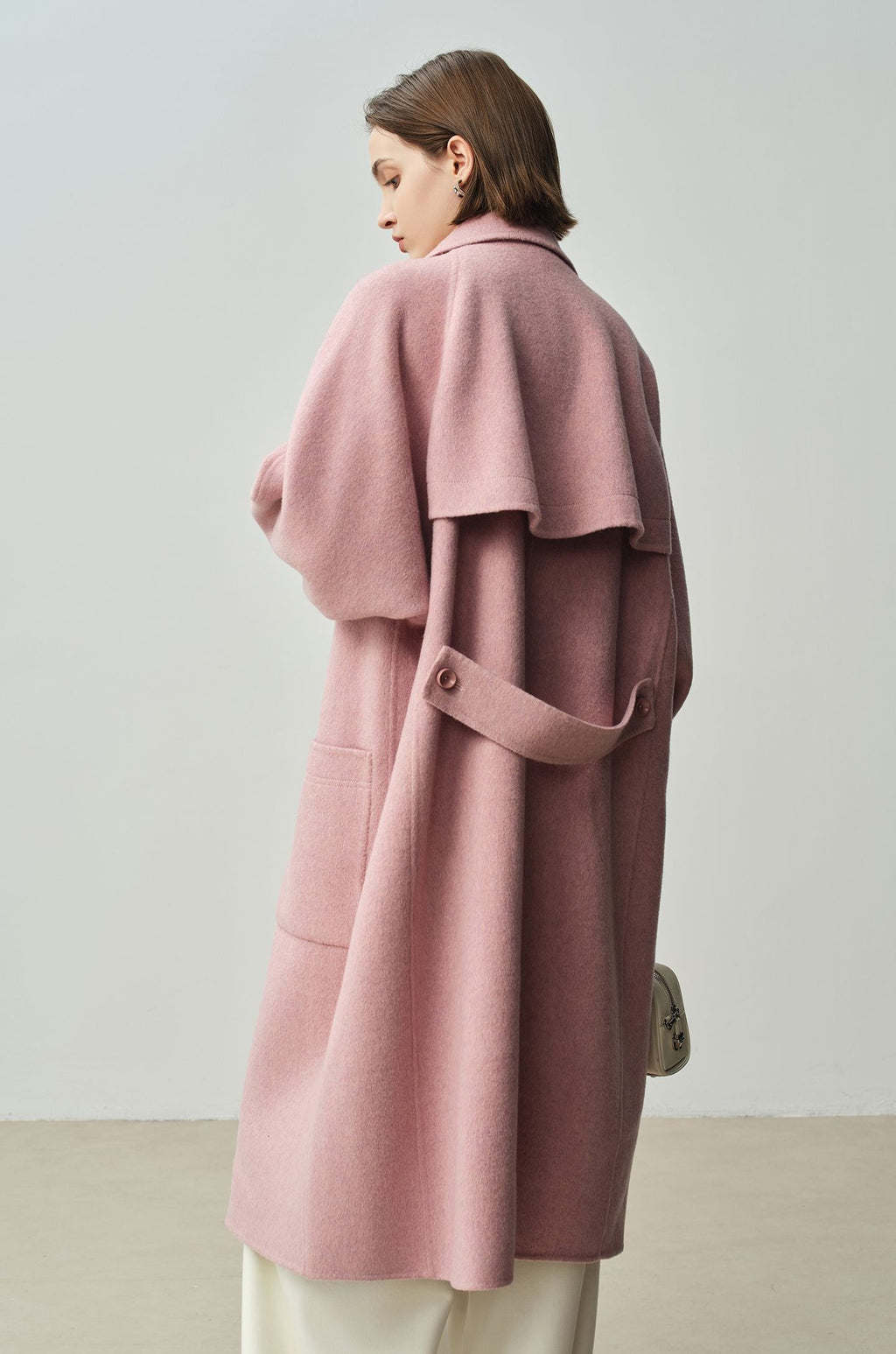 The Amaya Pastel Coat in soft pink fabric featuring a stylish oversized design and side pockets