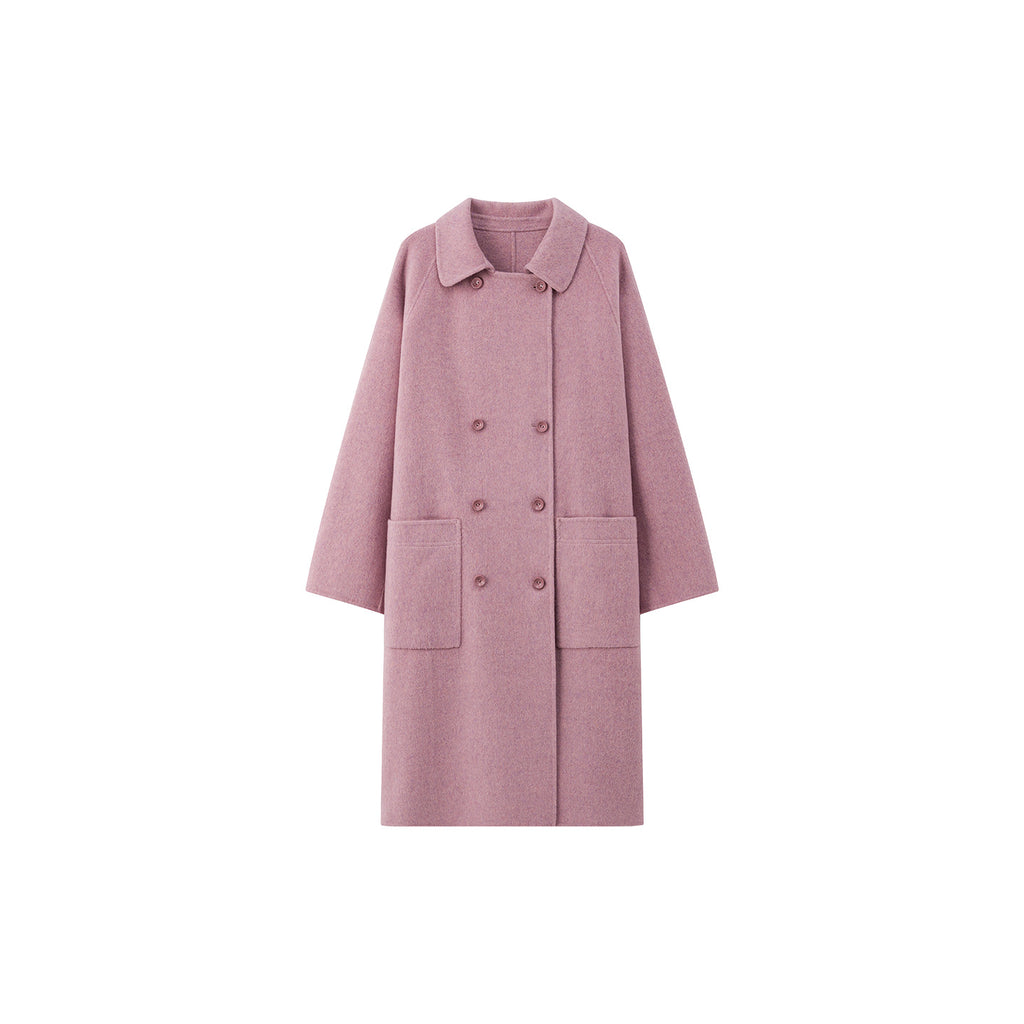 The Amaya Pastel Coat in soft pink featuring a double-breasted design and front pockets