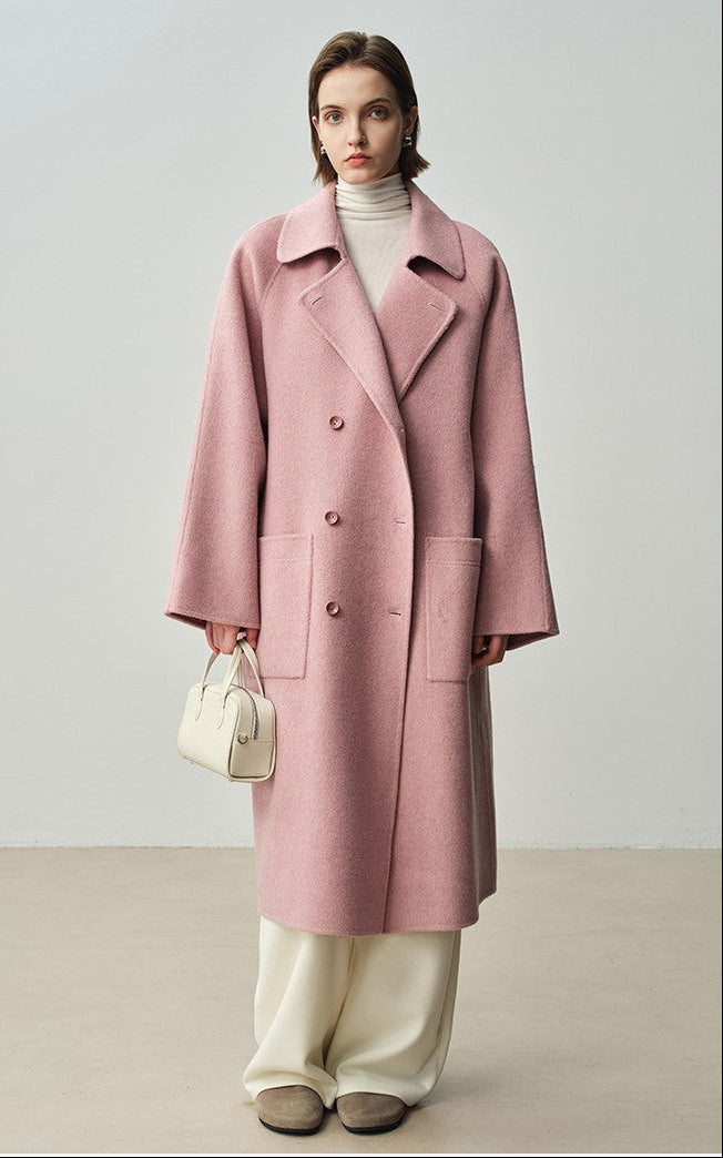 The Amaya Pastel Coat in soft pink, featuring a relaxed fit and large pockets, perfect for stylish comfort.