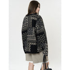 The Kyoto Jacquard Cardigan in black and gray with intricate patterns, perfect for layering.
