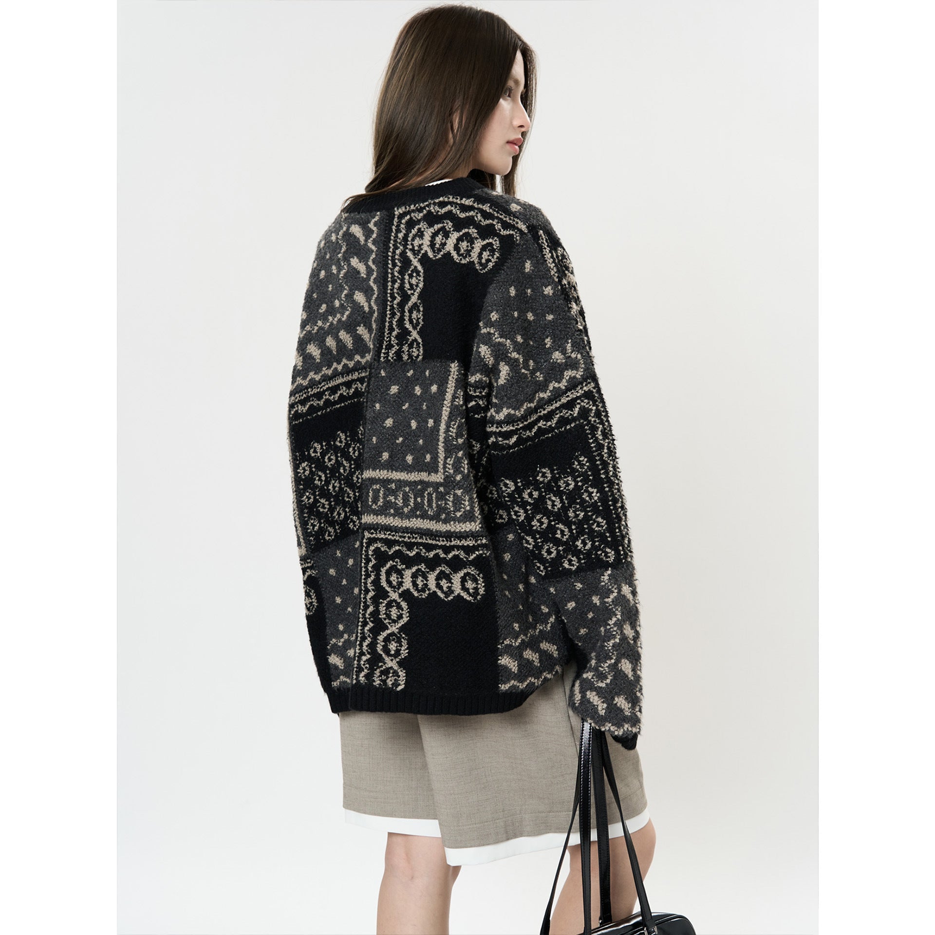 The Kyoto Jacquard Cardigan in black and gray with intricate patterns, perfect for layering.