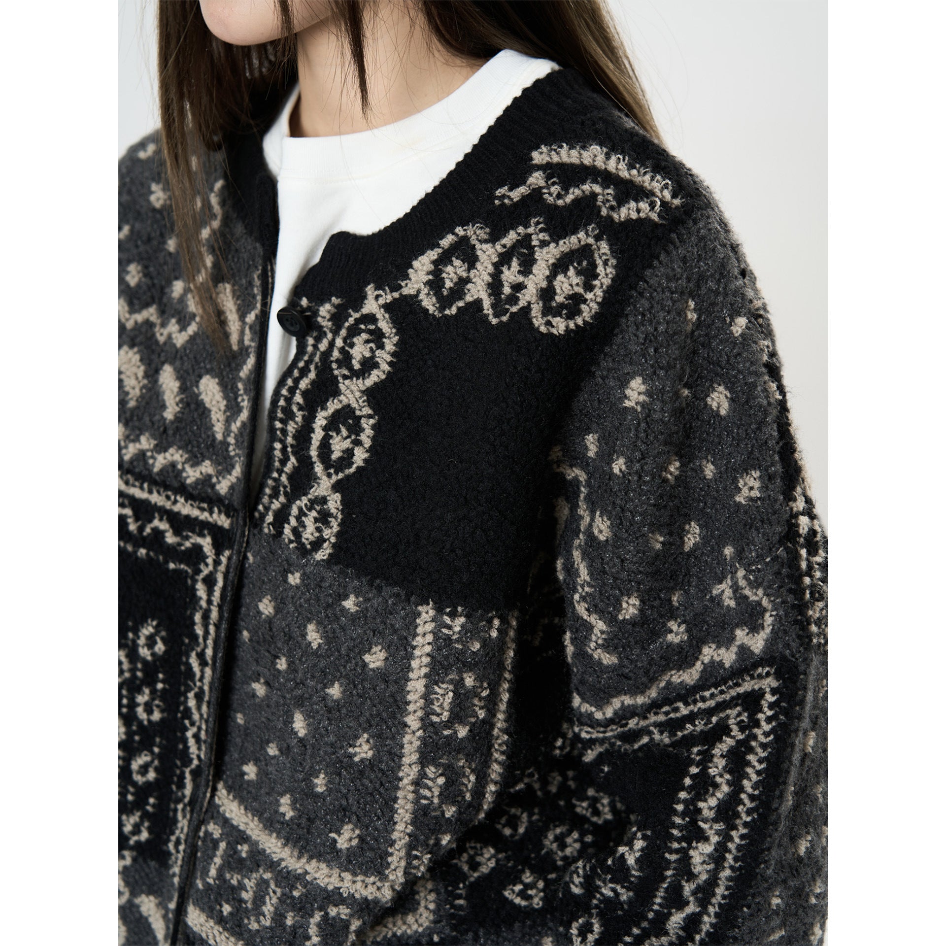 The Kyoto Jacquard Cardigan in black and beige with intricate design details and a cozy fit