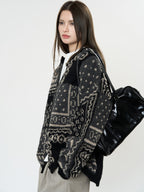 The Kyoto Jacquard Cardigan in black and cream with intricate patterns and a relaxed fit