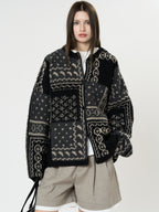 The Kyoto Jacquard Cardigan in black and gray patchwork design with a cozy fit