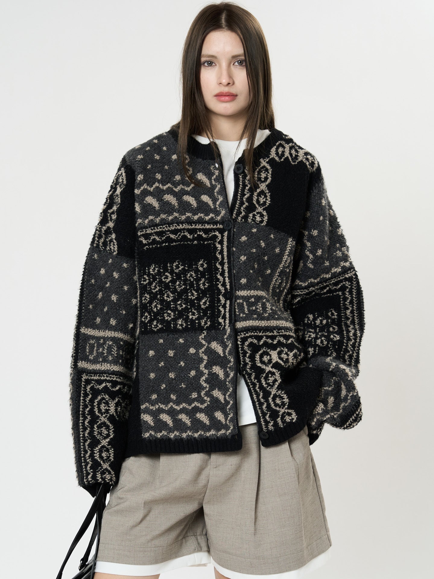 The Kyoto Jacquard Cardigan in black and gray patchwork design with a cozy fit