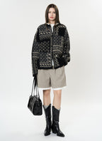 The Kyoto Jacquard Cardigan in black and cream with unique pattern design, paired with shorts and boots