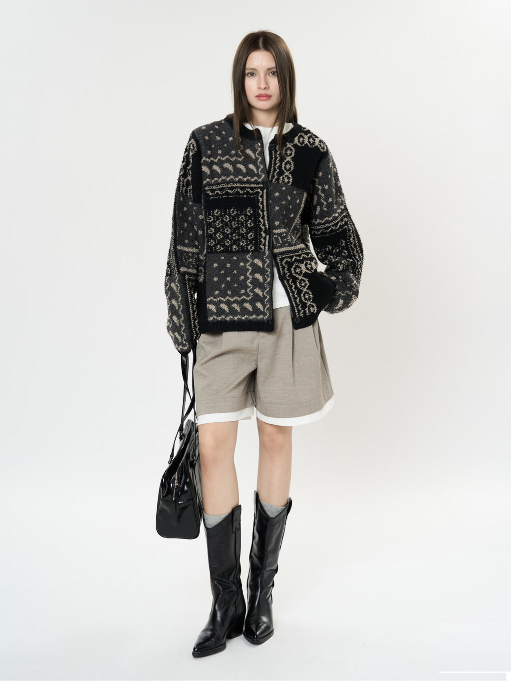 The Kyoto Jacquard Cardigan with unique patterns, paired with a white top and stylish shorts