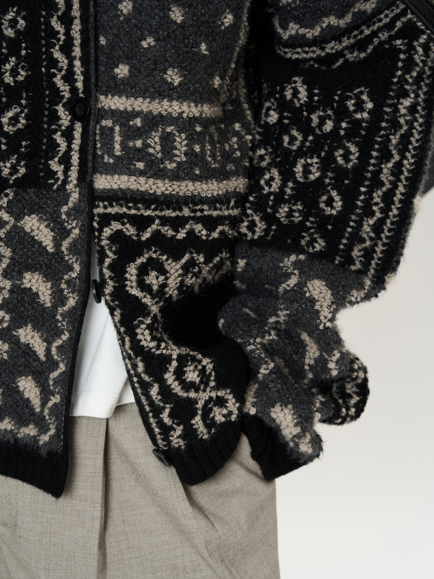 The Kyoto Jacquard Cardigan in black and gray featuring intricate patterns and a cozy design