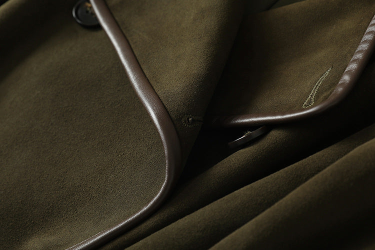 Close-up of The Margaux Trench Coat in olive green fabric with stylish brown trim and button details