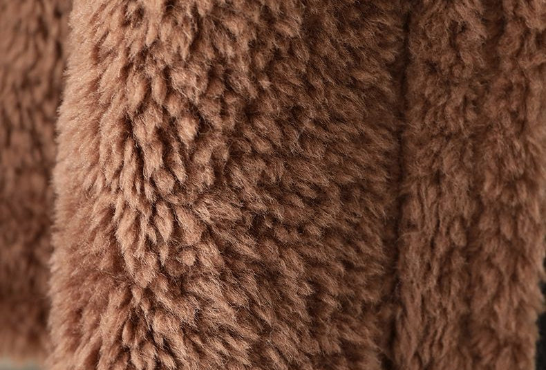 Close-up of The Panther Wool Coat showcasing its soft, fluffy texture in rich brown color