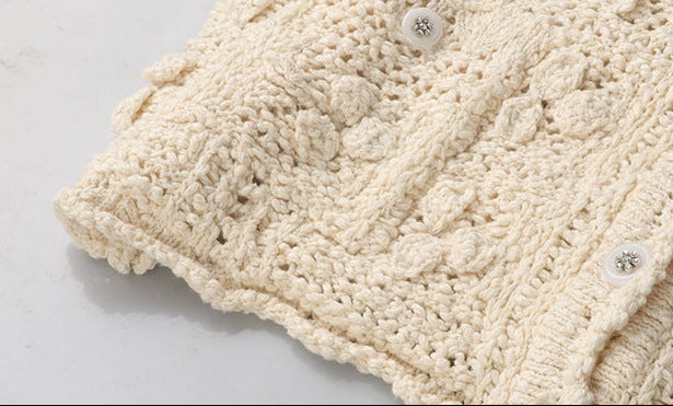 The Petale Knit, Hand Crocheted Wool Cardigan in creamy beige with intricate knitted patterns