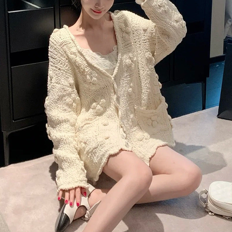 The Petale Knit, Hand Crocheted Wool Cardigan in cream color with a cozy oversized fit and front pockets