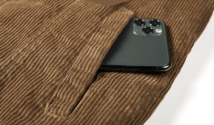 Close-up of a Thick Ribbed Velvet Jacket with Warm Lining featuring a pocket holding a smartphone