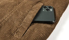 Close-up of a Thick Ribbed Velvet Jacket with Warm Lining featuring a pocket holding a smartphone