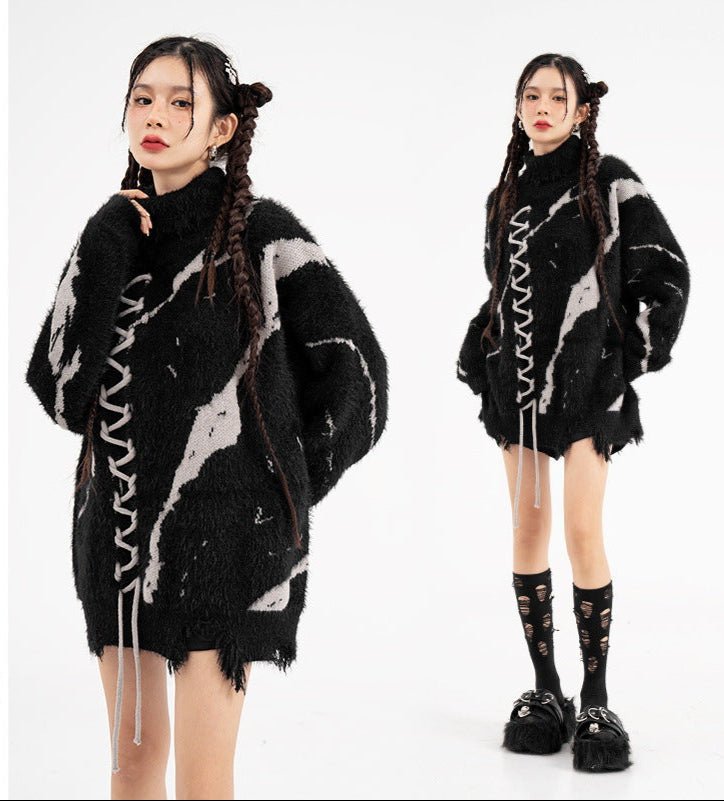 Model wearing an oversized sweater with dark street design and distressed details in a stylish urban setting