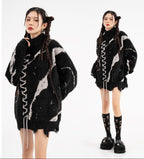 Model wearing an oversized sweater with dark street design and distressed details in a stylish urban setting
