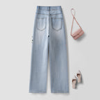 Twin Blossom Wide Leg Jeans in light blue with stylish back pockets and paired with a pink handbag and shoes