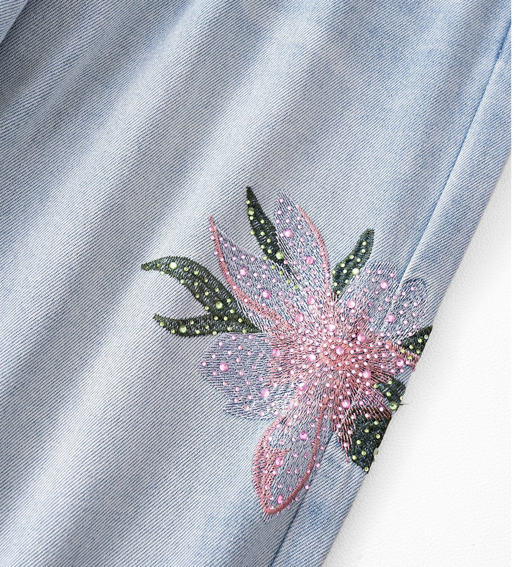 Twin Blossom Wide Leg Jeans featuring floral embroidery detail on light blue denim fabric