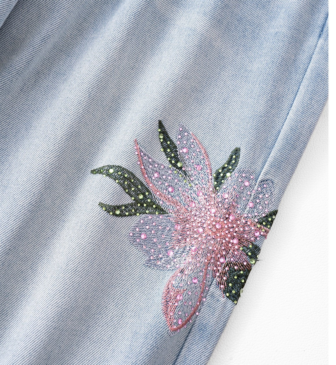 Twin Blossom Wide Leg Jeans featuring floral embroidery detail on light blue denim fabric