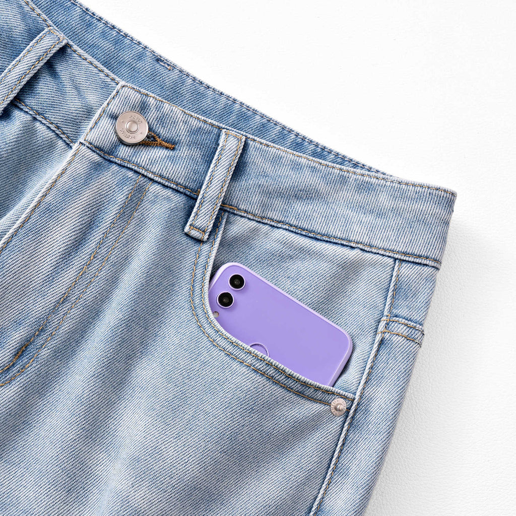 Close-up of AM Vision RO Twin Blossom Wide Leg Jeans with a phone in the front pocket