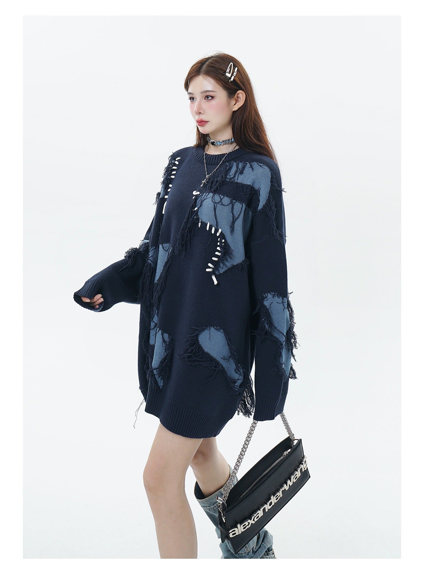 Model wearing a Unisex Streetwear Sweater With Irregular Pattern And Fringe Details, styled with accessories