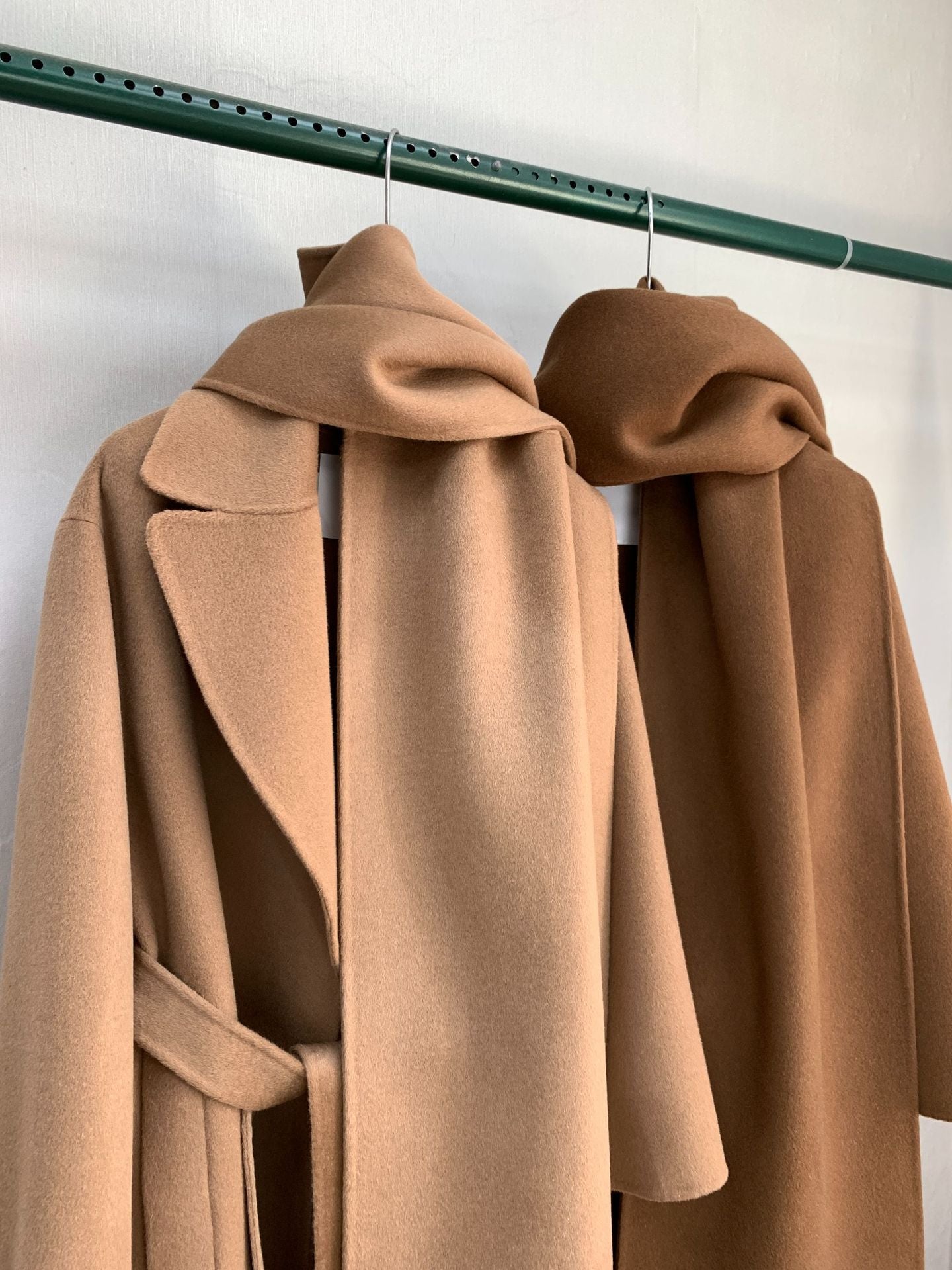 Urban Drift Double Face Wool Scarf Coat Camel and Caramel Edition hanging on a rack showcasing its luxurious fabric