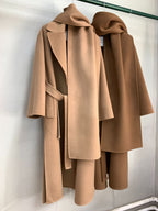 Urban Drift Double Face Wool Scarf Coat Camel and Caramel Edition hanging on a rack, showcasing elegant design and soft fabric