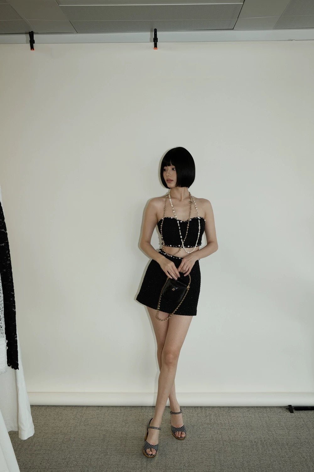 Model wearing the Valeria Tweed Set Jacket, Bra, Skirt with stylish accessories for a chic look