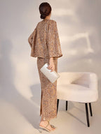 Elegant camel midi skirt with geometric sequins paired with a shimmering top and clutch