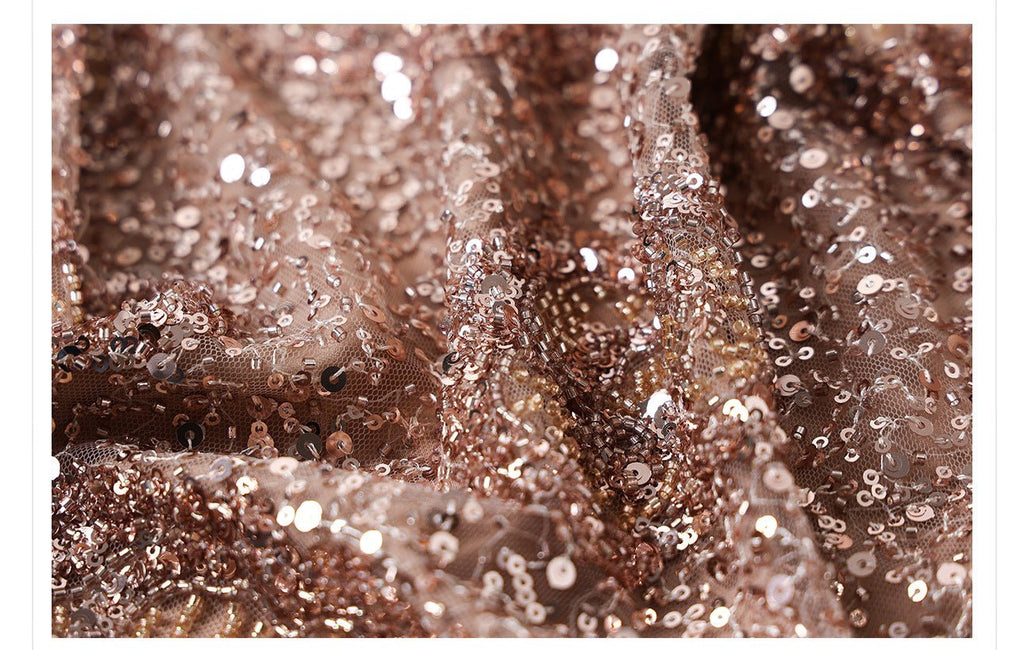 Close-up of camel midi skirt with geometric sequins showcasing shimmering details and texture