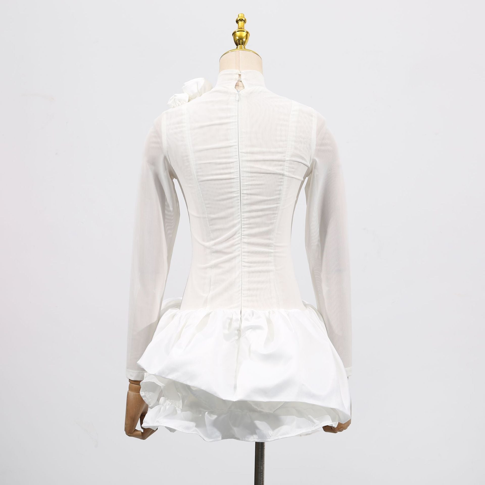 Back view of the White Dress With 3D Flowers And Voluminous Skirt, showcasing elegant details and design