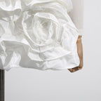 Close-up of a White Dress With 3D Flowers And Voluminous Skirt showcasing floral details and texture