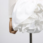 Elegant White Dress With 3D Flowers And Voluminous Skirt on a mannequin showcasing its detailed design