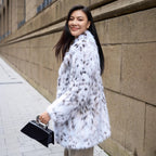 Stylish model wearing a White Luxe Lynx Coat with a soft faux fur design, perfect for winter fashion