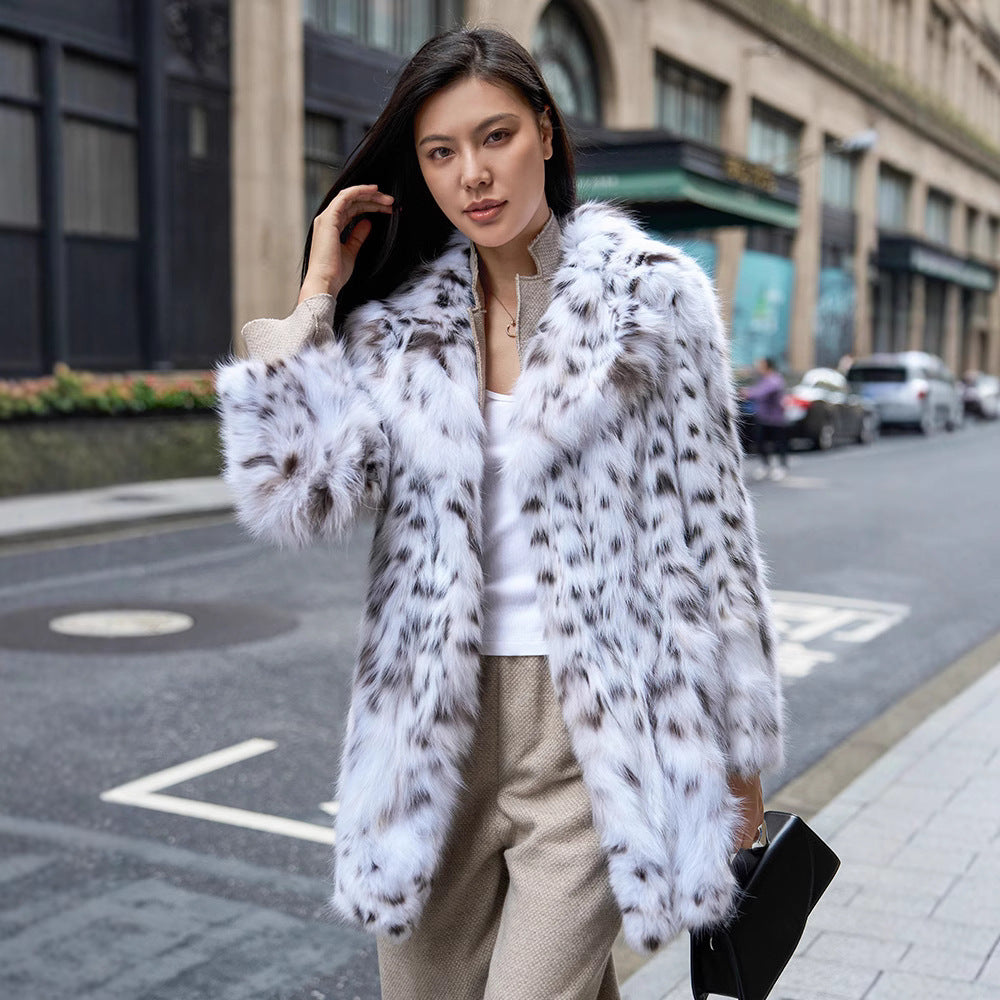 Fashionable model wearing a White Luxe Lynx Coat with a stylish fur design in an urban setting