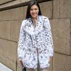 Woman wearing a stylish White Luxe Lynx Coat for a chic and elegant look on the street