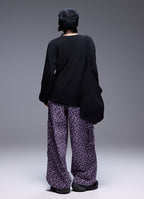 Back view of model wearing Wild Urban Leopard Cargo Pants with relaxed fit and stylish pattern